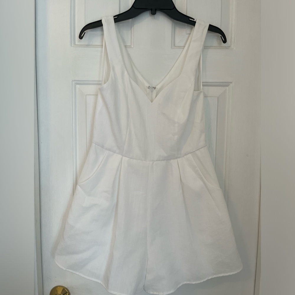 White romper with pockets.